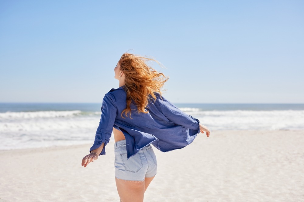 GLP-1 Weight Loss in Bedford 5 Beautiful Young Woman With Red Hair Walking On The Beach